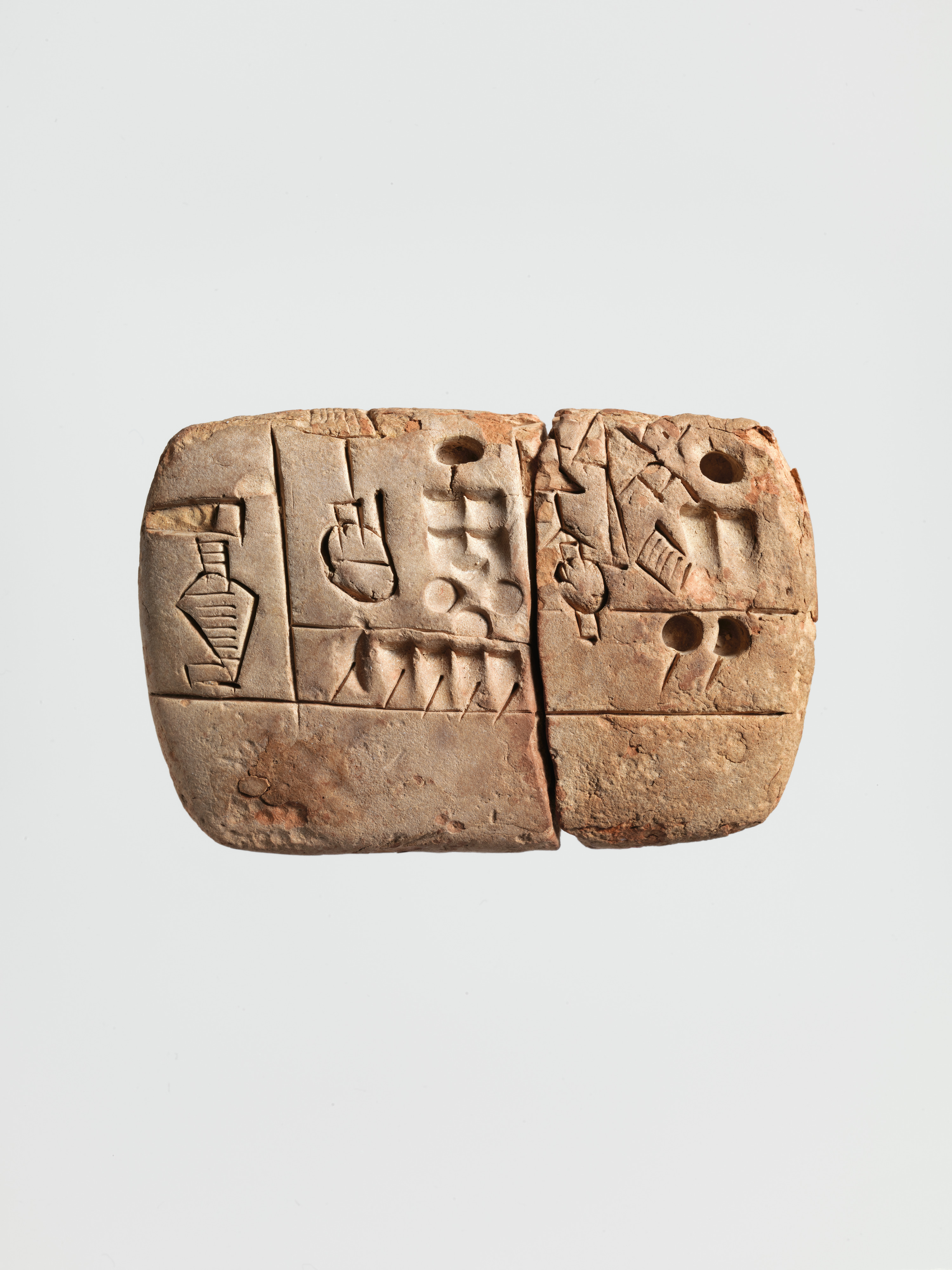 Early clay account divided into fields, with round number impressions and drawn commodity signs.