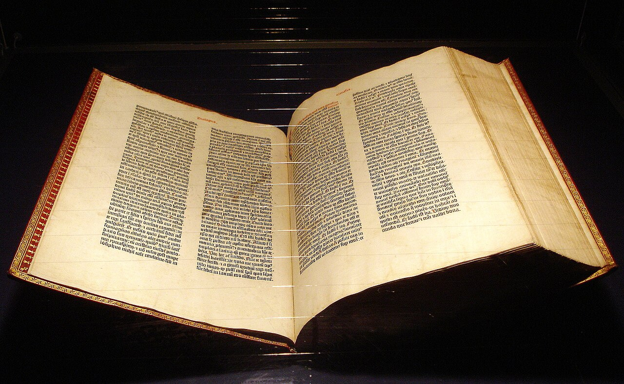 An open Gutenberg Bible displayed in Mainz shows two columns of black text on each page.