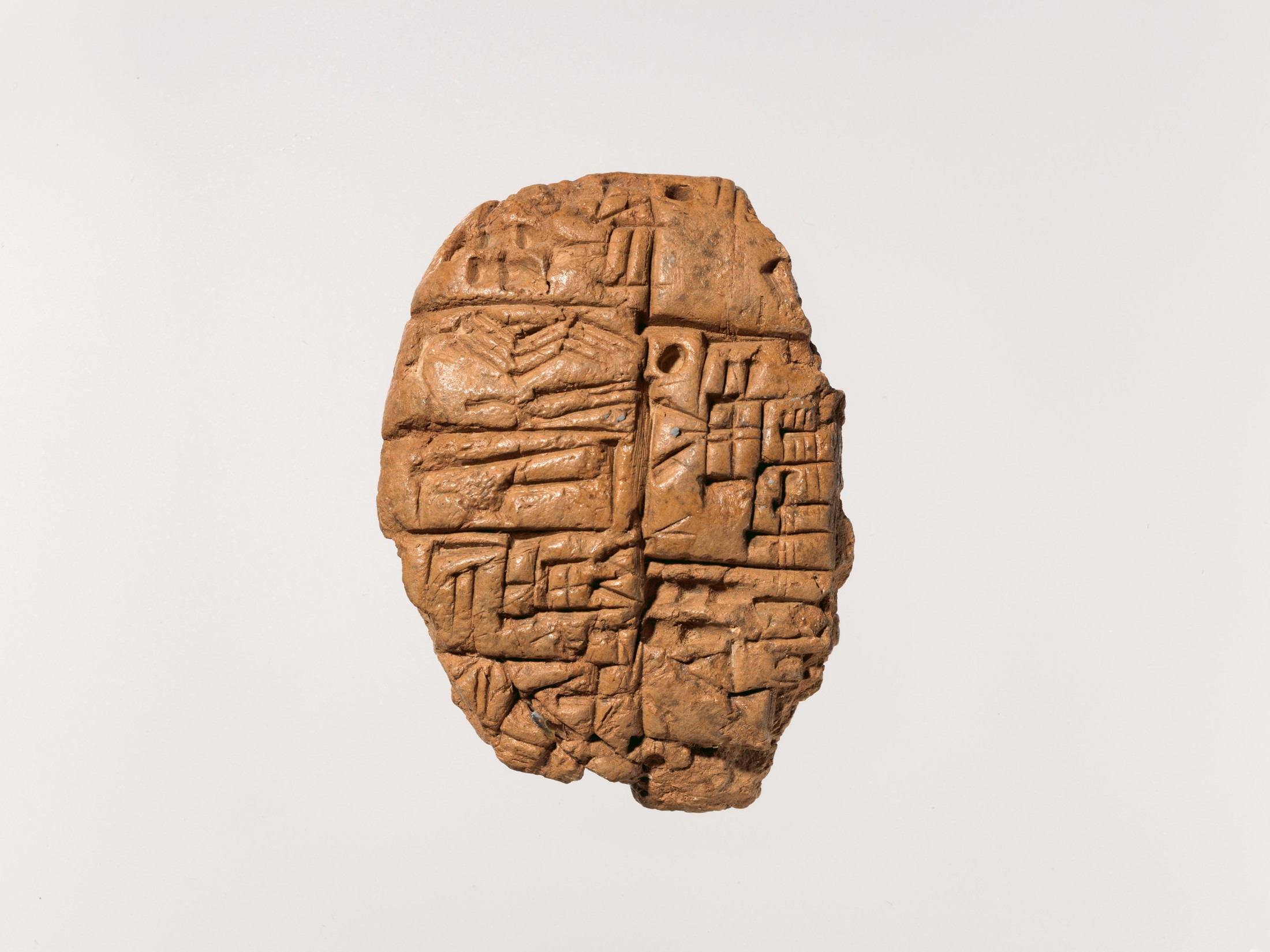 A clay tablet from Nippur is covered with rows of cuneiform writing.