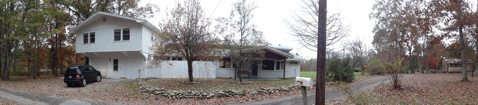 A panoramic photograph shows buildings, trees and a driveway at the former Highlander Folk School site.
