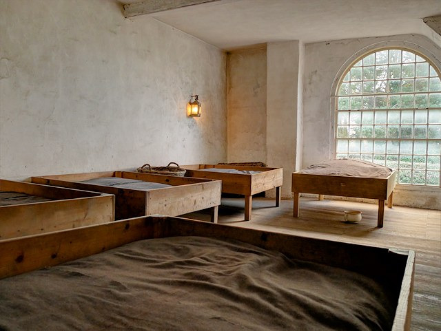 A modern museum display of the girls’ dormitory at Quarry Bank Apprentice House.